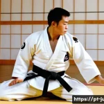 유도와 신체적 균형 - **Judo Ukemi (Falling Technique) in a Traditional Dojo**
    An athletic male judoka, in his late 20...